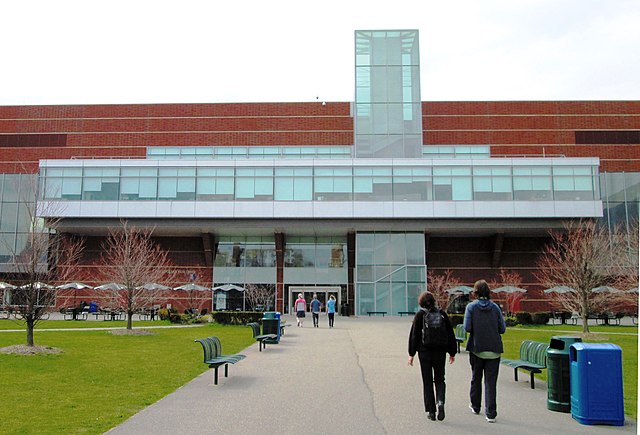 College building with students walking toward it